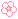A small white pixel flower.